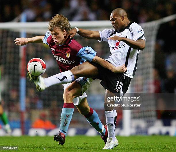 Collins John of Fulham tackles Martin Laursen of Aston Villa during the Barclays Premiership match between Aston Villa and Fulham at Villa Park on...