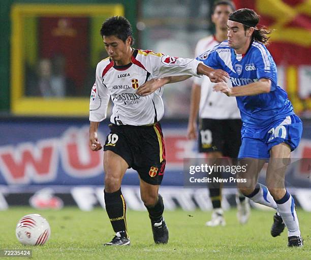 Mitsuo Ogasawara of Messina is challenged by Daniele Buzzegoli of Empoli during the Serie A match between Messina and AC Milan at the Stadio Giovanni...