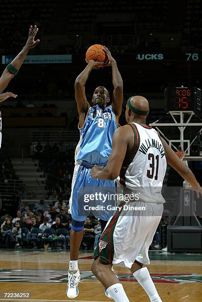 Joe Smith of the Denver Nuggets shoots a jump shot against Charlie Villanueva of the Milwaukee Bucks October 21, 2006 at the Bradley Center in...