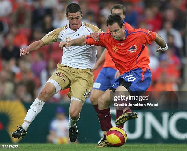 Ante Milicic of the Roar is pressured by Mark Bridge of the Jets during the round nine Hyundai A-League match between the Queensland Roar and the...