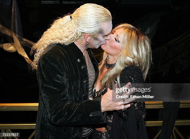 Twisted Sister singer Dee Snider kisses his wife Suzette backstage after their wedding vow renewal ceremony following a performance of Dee Snider's...