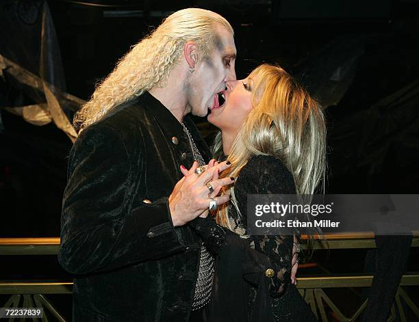 Twisted Sister singer Dee Snider kisses his wife Suzette backstage after their wedding vow renewal ceremony following a performance of Dee Snider's...