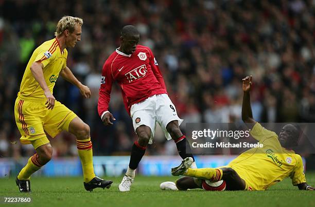 Momo Sissoko of Liverpool slides in to challenge Louis Saha of Manchester United for the ball during the Barclays Premiership match between...