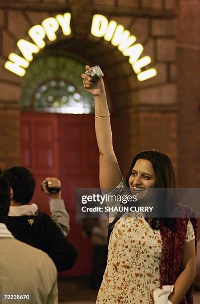 Leicester, UNITED KINGDOM: People photograph the Diwali festival of light 21 October 2006 as hundreds thronged the center of Leicester, closed to...