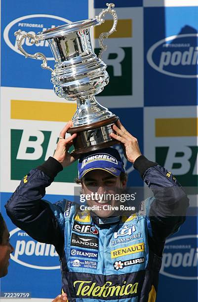 Fernando Alonso of Spain and Renault celebrates winning the World Championship after finishing second in the Brazilian Formula One Grand Prix at the...