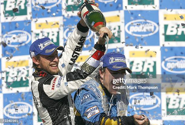 Fernando Alonso of Spain and Renault is doused with Champaign after winning the winning the World Championship by Jenson Button of Great Britain and...