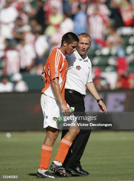 Head Coach Dominic Kinnear of the Houston Dynamo has a word with his player Brian Ching after they lost to Chivas USA 2-1 in the first game of their...