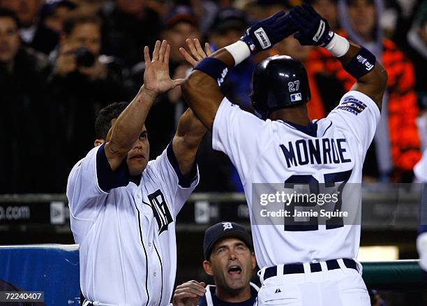 Ivan Rodriguez of the Detroit Tigers congratulates Craig Monroe after he hit a solo home run in the bottom of the first inning against Jeff Weaver of...