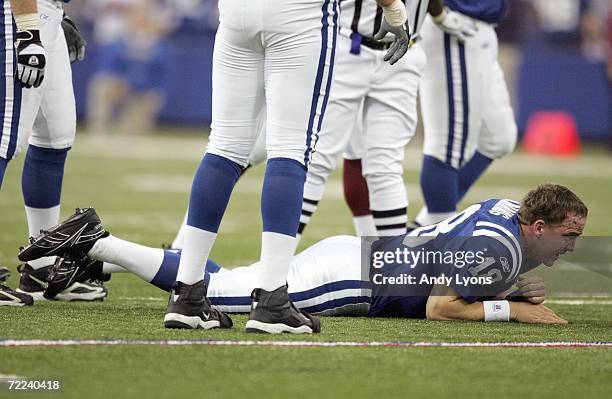 Peyton Manning of the Indianapolis Colts lost his helmet after getting hit while he threw a pass during the NFL game against the Washington Redskins...