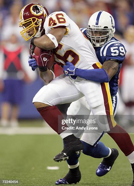 Ladell Betts of the Washington Redskins runs with the ball while Cato June of the Indianapolis Colts tackles him during the NFL game on October 22,...