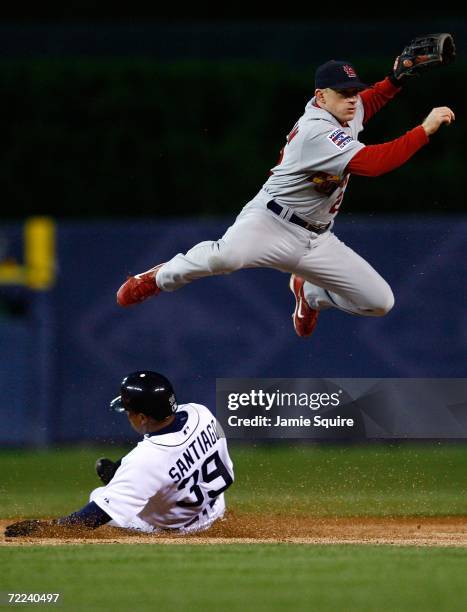 David Eckstein of the St. Louis Cardinals successfully turns a double play over a sliding Ramon Santiago of the Detroit Tigers on a ball hit by...