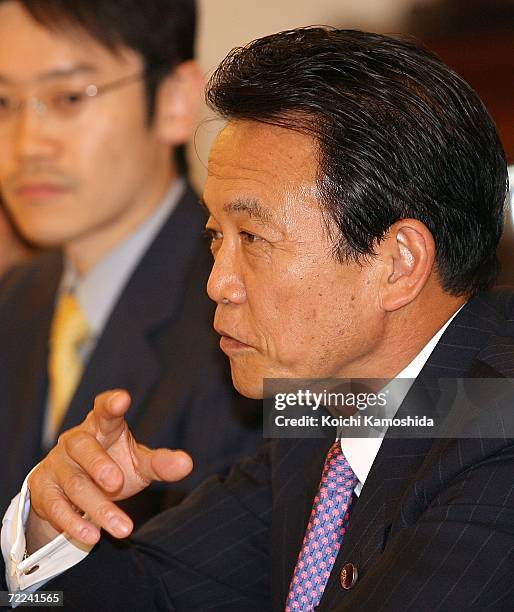 Japanese Foreign Minister Taro Aso talks with Iraqi oil minister Hussain al-Shahristani at the Japanese Ministry of Foreign Affairs on October 23,...