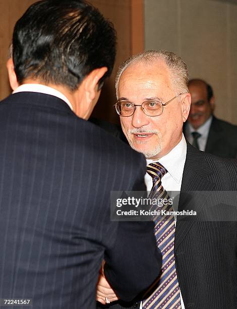 Iraqi oil minister Hussain al-Shahristani shakes hands with Japanese Foreign Minister Taro Aso at the Japanese Ministry of Foreign Affairs on October...