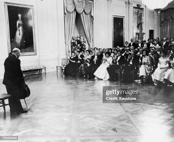 Spanish cellist Pablo Casals gives a recital for American president John F. Kennedy and Jackie Kennedy at the White House, 24th November 1961.