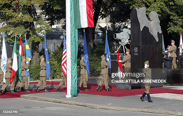 Hungarian honour guards march with national flags in front of the monument of 1956 revolution at Kossuth Square of downtown Budapest 23 October 2006...