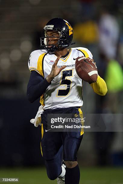 Quarterback Patrick White of the West Virginia University Mountaineers looks to pass against the University of Connecticut Huskies at Rentschler...