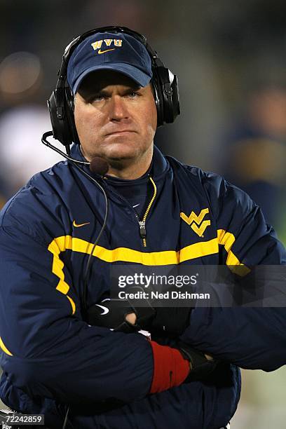 Head coach Rich Rodriguez of the West Virginia University Mountaineers stands on the sideline against the University of Connecticut Huskies at...