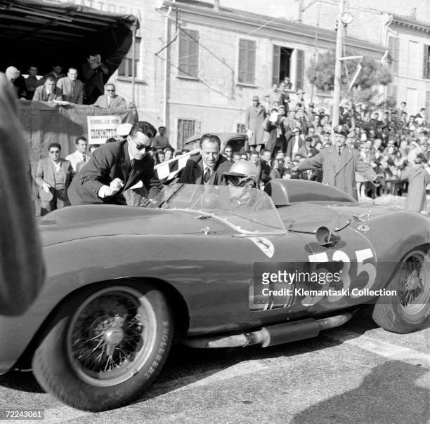 Italian racing driver Piero Taruffi in his Ferrari at Ravenna during the Mille Miglia, May 1957. He went on to win the race which was the last to be...