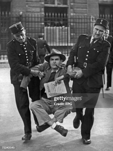 French lawyer Henri Marcais is forcibly removed from outside the Palais Bourbon, seat of the French National Assembly in Paris, 31st May 1950. Mr...