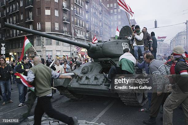 Demonstrators driving a 1950s-era tank they had commandeered drive through other massed demonstrators on their way to charging a police cordon during...