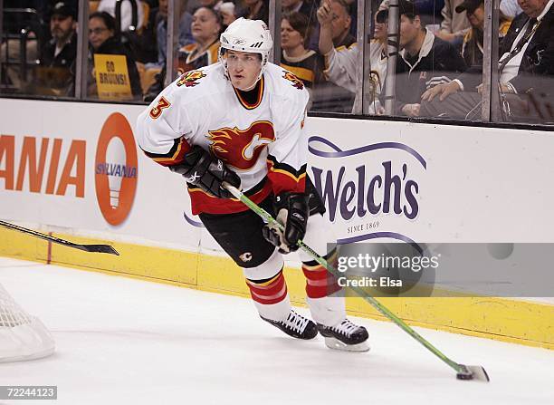 Dion Phaneuf of the Calgary Flames skates the puck around the net against the Boston Bruins on October 19, 2006 at TD Banknorth Garden in Boston,...