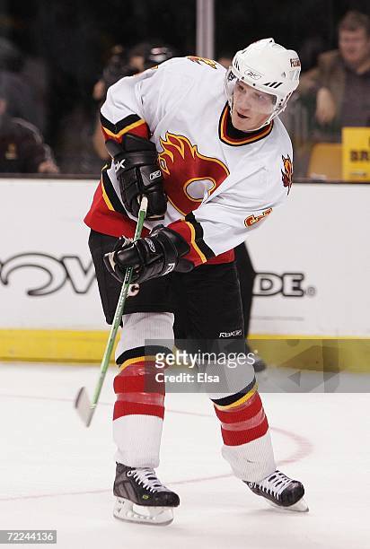 Dion Phaneuf of the Calgary Flames follows through on a pass against the Boston Bruins on October 19, 2006 at TD Banknorth Garden in Boston,...