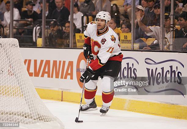 Stephane Yelle of the Calgary Flames looks to make a play from behind the net against the Boston Bruins on October 19, 2006 at TD Banknorth Garden in...