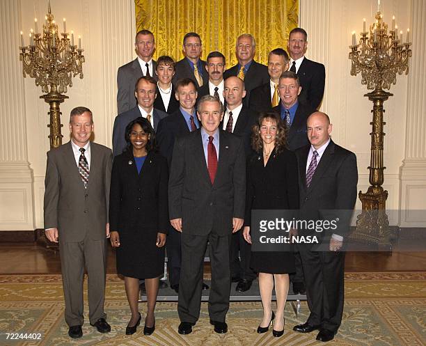 In this handout provided by NASA, U.S. President George W. Bush poses with Crew Members of the Space Shuttle Discovery , Space Shuttle Atlantis , and...