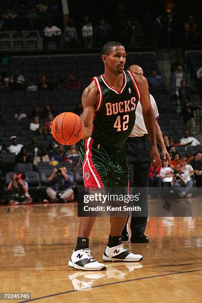 Charlie Bell of the Milwaukee Bucks looks to move the ball during a preseason game against the Charlotte Bobcats at Charlotte Bobcats Arena on...