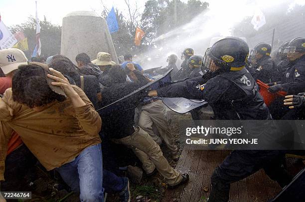 South Korean protesters clash with riot police during an anti-FTA rally in the southern island of Jeju, 24 October 2006. South Korea and the United...