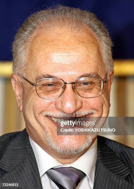 Visiting Iraqi Oil Minister Hussain al-Shahristani smiles to the press in Tokyo 24 October 2006 after meeting with Japanese trade minister Akira...