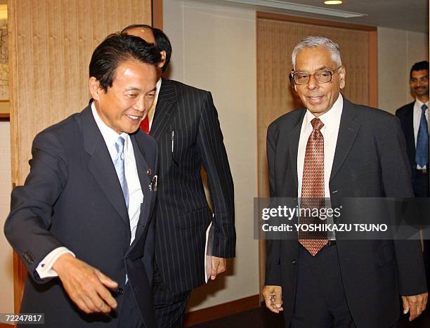 Visiting Indian National Security adviser M.K. Narayanan is greeted by Japanese Foreign Minister Taro Aso for their talks in Tokyo, 24 October 2006....
