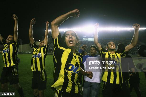 Beitar Jerusalem players, wearing the team's black-and-gold colours, celebrate their 3-0 victory over Maccabi Herzliya on Sunday evening October 22,...