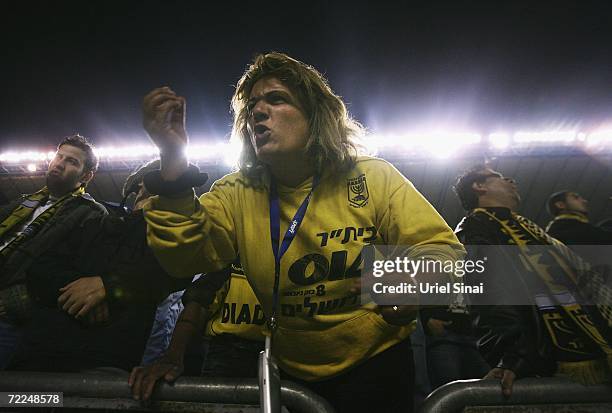 Beitar Jerusalem soccer fan, draped in her team's black-and-gold colours, shouts her support as her team cruises to a 3-0 victory over Maccabi...