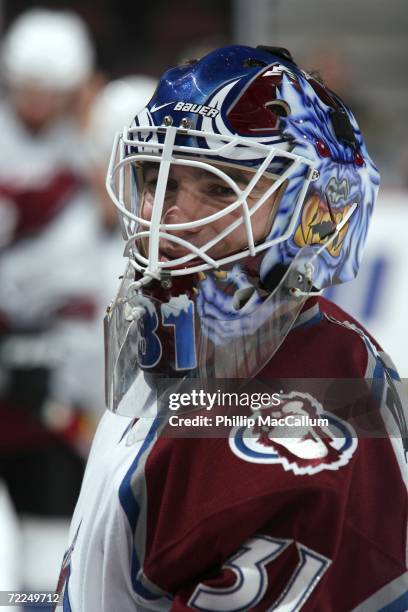 Peter Budaj of the Colorado Avalanche talks to a trainer on the bench during warm-up before a game against the Ottawa Senators on October 19, 2006 at...