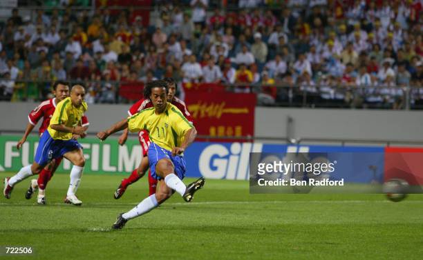 Ronaldinho of Brazil scores from the penalty spot during the FIFA World Cup Finals 2002 Group C match between Brazil and China played at the...