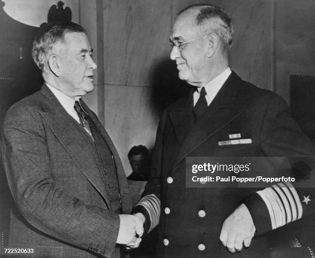 American Democratic Party politician and United States Senator from Kentucky, Alben W Barkley shakes hands with Admiral James O Richardson during the...