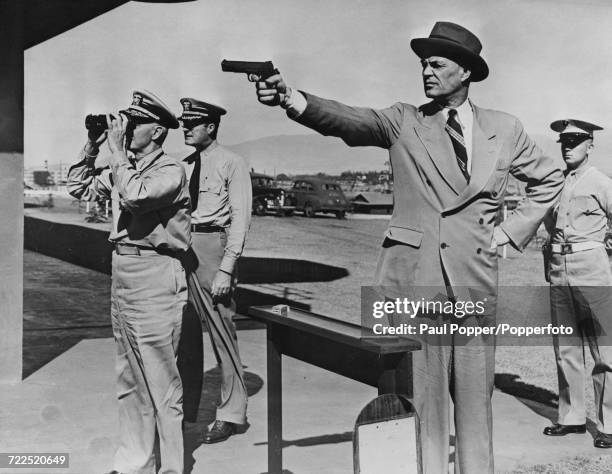 Assistant Secretary of the Navy Ralph Austin Bard shoots a pistol on a target range during an inspection of the Pacific Fleet base at Pearl Harbor in...
