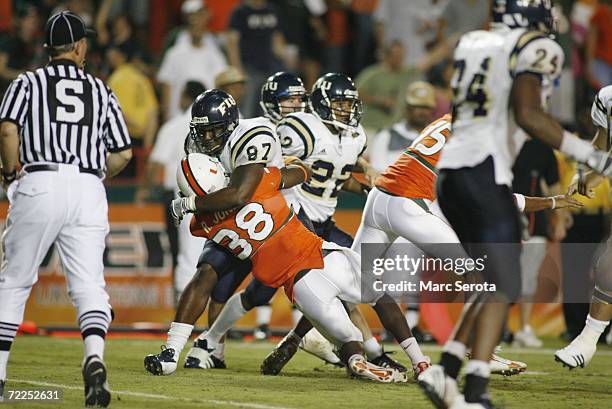 Samuel Smith of the Florida International Panthers fights Rashaun Jones of the Miami Hurricanes during an on field fight at the Orange Bowl on...