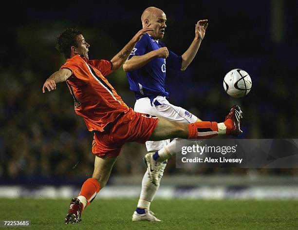 Keith Keane of Luton Town tackles Andy Johnson of Everton during the Carling Cup third round match between Everton and Luton Town at Goodison Park on...