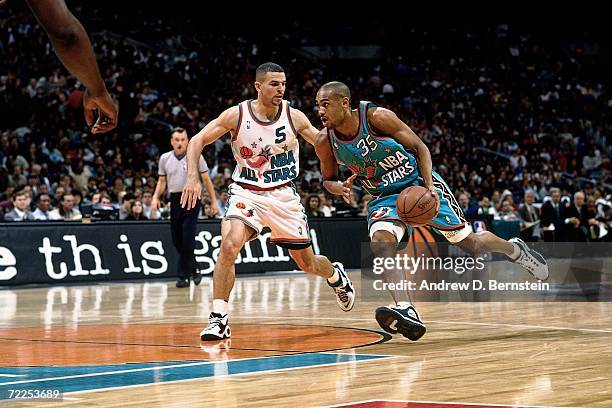 Grant Hill of the Eastern Conference All-Stars drives to the basket against Jason Kidd of the Western Conference All-Stars during the 1996 NBA...