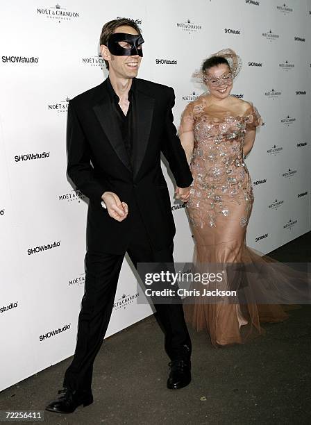 Photographer Nick Knight and guest arrive at the Moet & Chandon Fashion Tribute to Knight on October 24, 2006 in London, England.