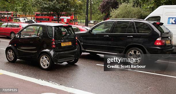 L4x4 vehicle passes a SMART car on October 25, 2006 in London, England. Gas-guzzling vehicles are being targeted by local authorities to face higher...