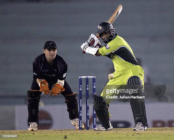 Mohammad Yousuf of Pakistan is watched by the New Zealand Brendon McCullum as he attacks the bowling of Daniel Vettori during the ICC Champions...