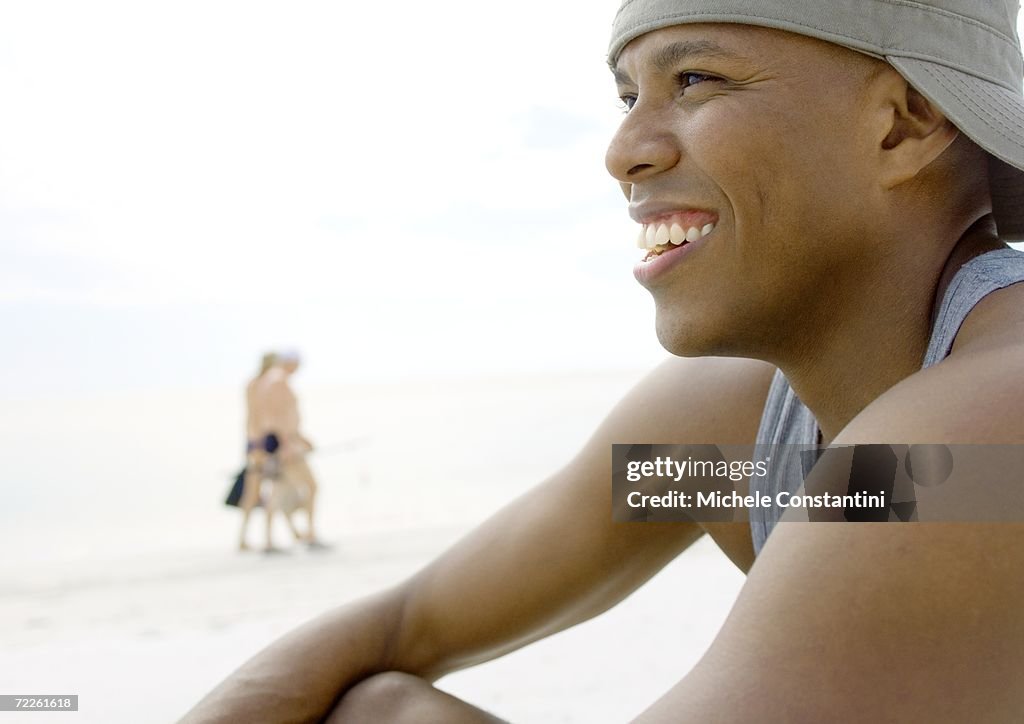 Man on beach, smiling