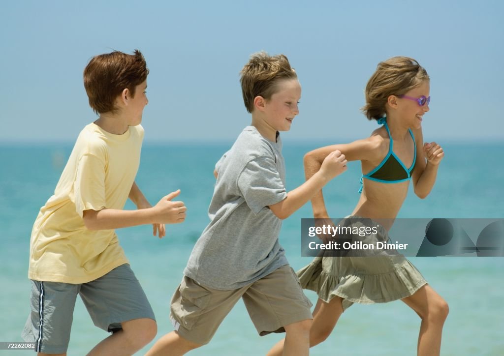 Three Kids Racing Three Children Racing On Beach High-Res Stock Photo - Getty Images