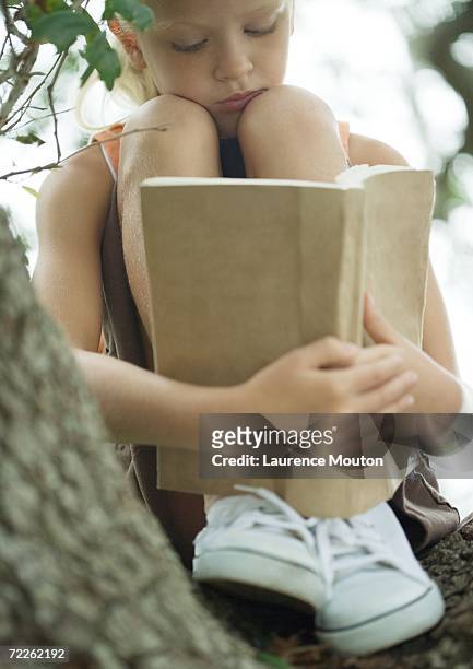 girl in tree reading book - girl sitting with legs open stock pictures, royalty-free photos & images