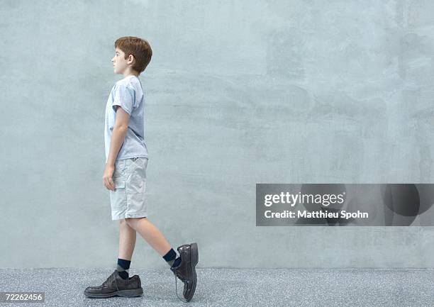 boy walking in oversized shoes - kid in big shoes stock pictures, royalty-free photos & images