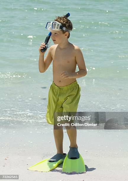 boy wearing scuba gear on beach - bermuda snorkel stock pictures, royalty-free photos & images