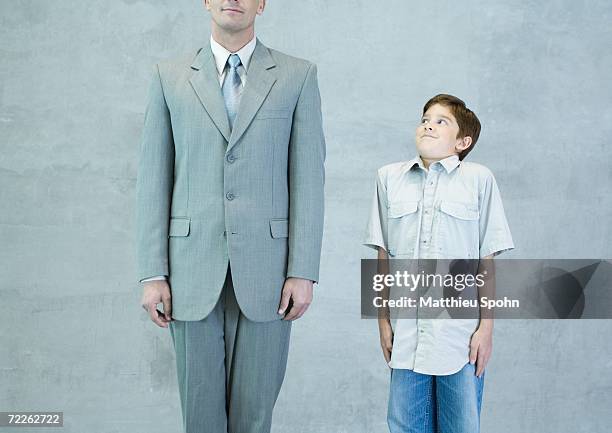 boy imitating businessman - moue de dédain photos et images de collection